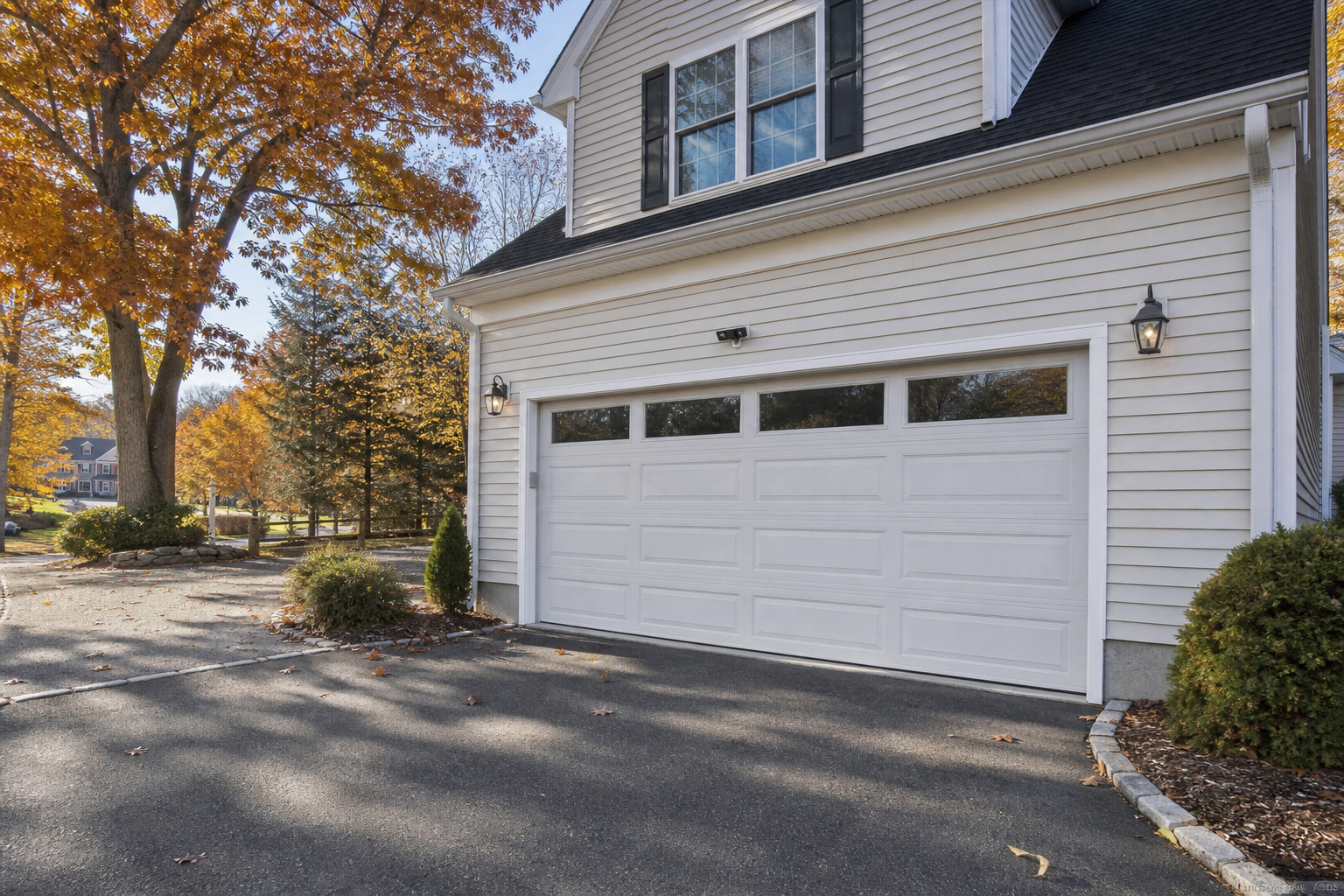 Suburban Livingston garage with a visible smart garage door in autumn light